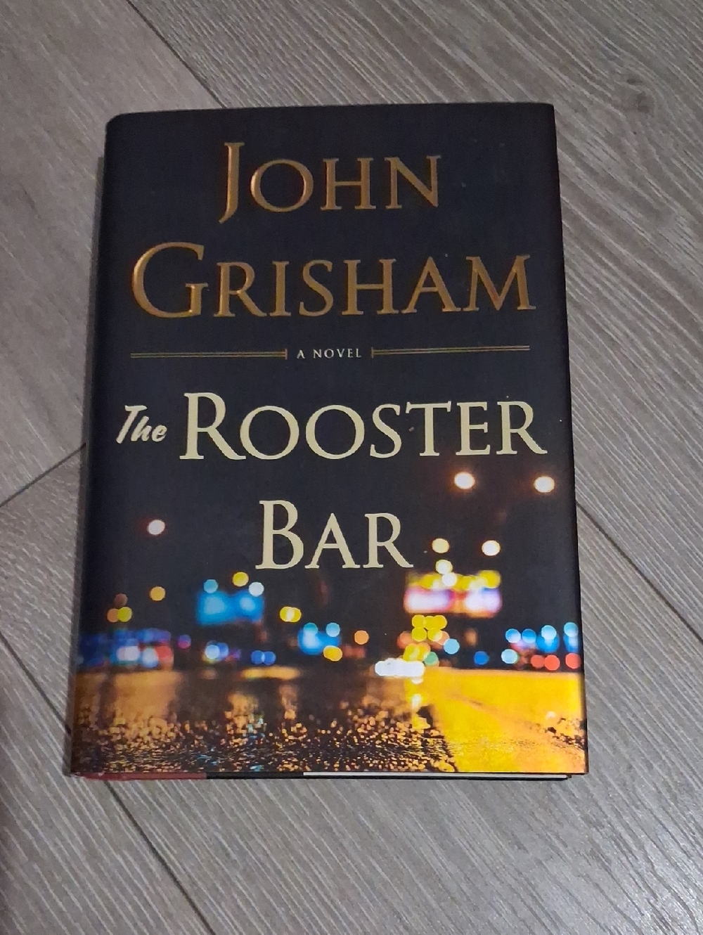 John Grisham "The Rooster Bar" Hardcover - Black with City Lights
